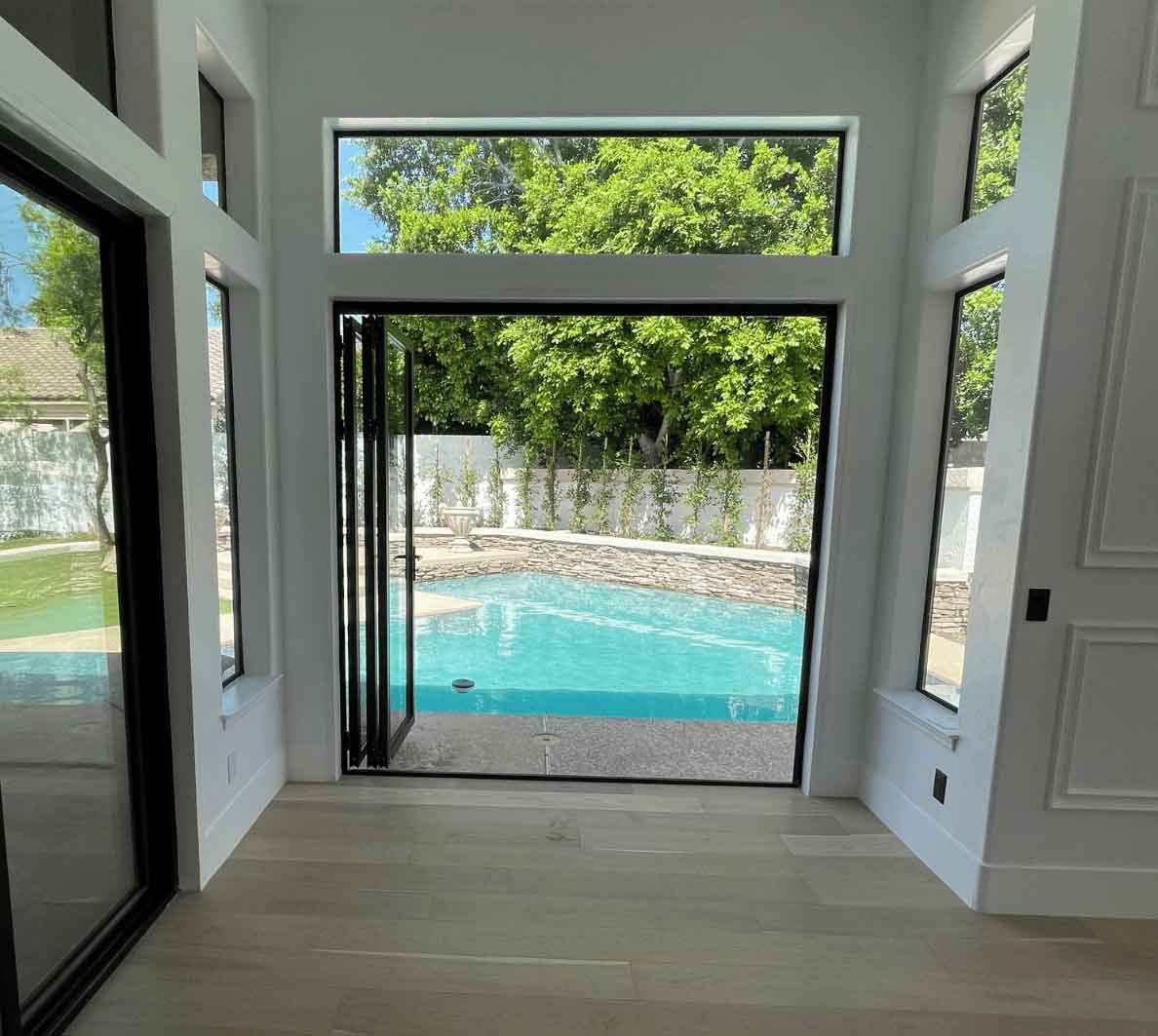 Sarasota area back yard with a pool view through panoramic doors