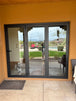 Dalmatian looking through updated folding patio doors